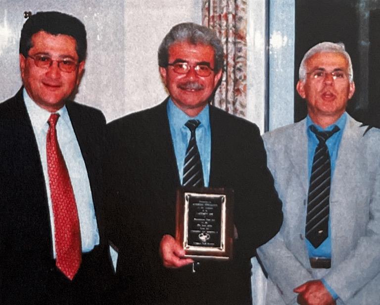 Spyros with The Captain Rreceiving his momento from The President Andreas Petrou