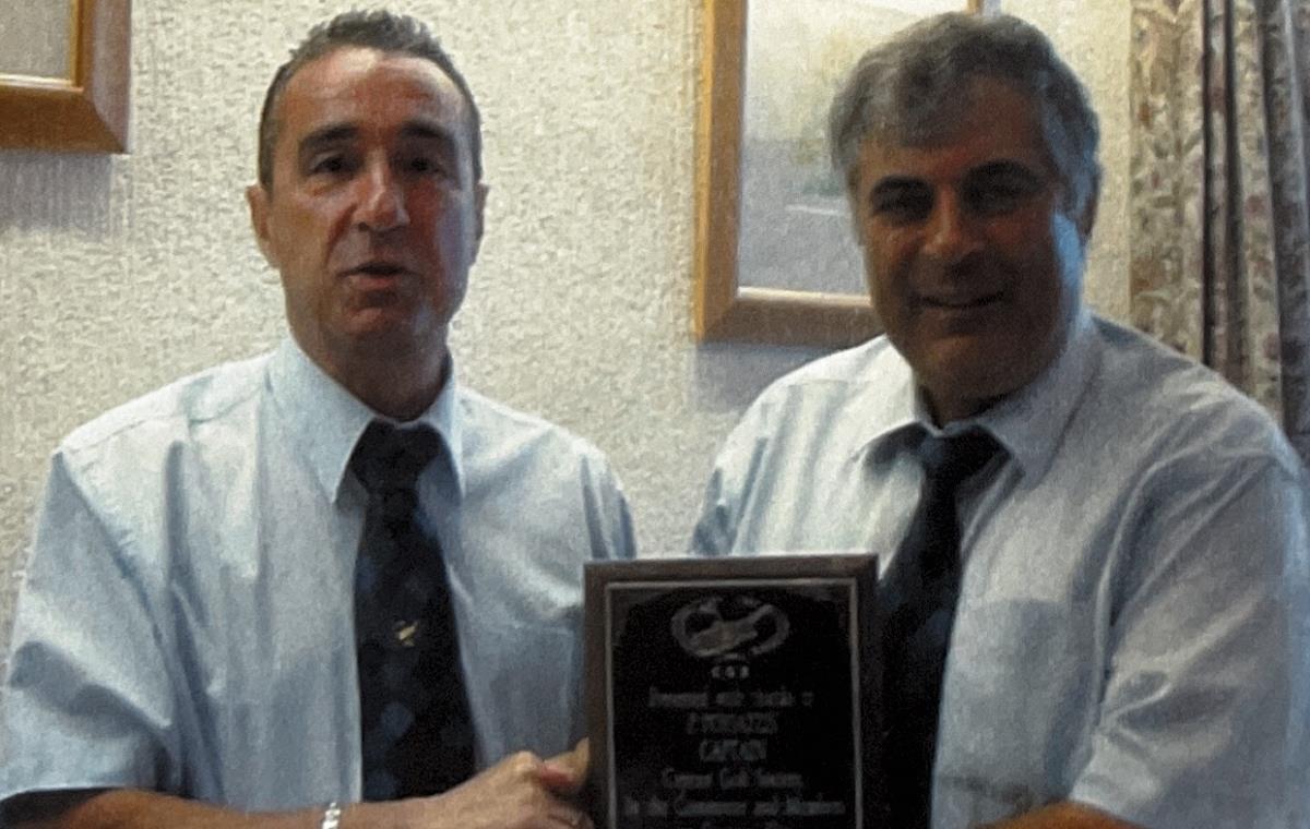 The Captain receiving his momento from The President
